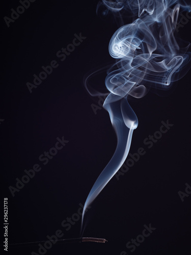 Abstract cloud of white smoke swirling, isolated on black background, close up view. Structure of smoke, brush effect. Abstract background of burning incense. Fragrance for meditation
