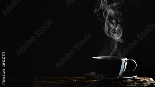 Obraz na plátne hot coffee, tea or chocolate in black cup on wooden plank