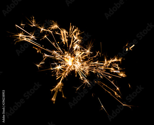 burning sparkler on dark background.