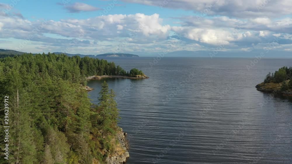 Aerial view over inlet, ocean and island with boat and mountains in beautiful British Columbia. Canada. 4K. Aerial view over inlet, ocean and island with boat and mountains in beautiful British Columbia. Canada. 4K.