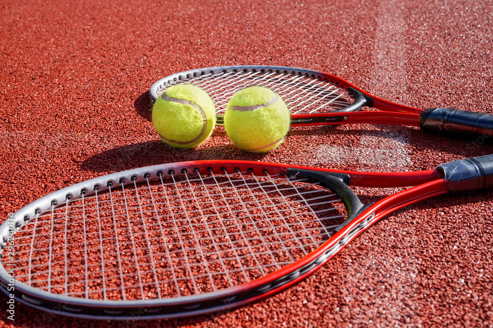 Low angle view tennis scene with balls and racquet
