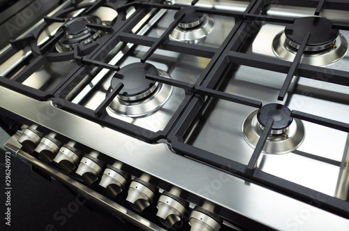 Close up of a brand new and clean stainless steel stove top/hop or a gas cooktop. photo