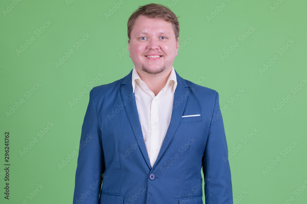 Portrait of happy overweight bearded businessman smiling Portrait of happy overweight bearded businessman smiling