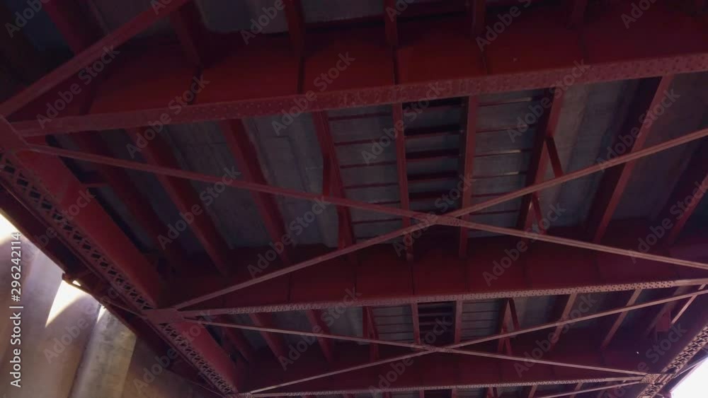 Looking up at underside of red beams of large drawbridge. Looking up at underside of red beams of large drawbridge.