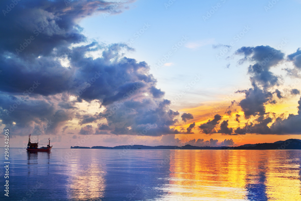 Morning golden sunrise on blue sea, ship silhouette and clouds scenic landscape, scenery ocean bright colorful sunset, beautiful seascape, boat and sun reflection on water, Thailand, Koh Samui island Morning golden sunrise on blue sea, ship silhouette and clouds scenic landscape, scenery ocean bright colorful sunset, beautiful seascape, boat and sun reflection on water, Thailand, Koh Samui island