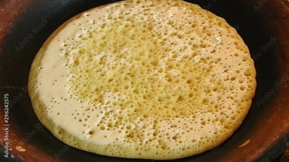 Food shot of some Homemade traditional Moroccan Baghrer in clay fryer , pancakes Baghrir or crapes with 1000 holes Food shot of some Homemade traditional Moroccan Baghrer in clay fryer , pancakes Baghrir or crapes with 1000 holes