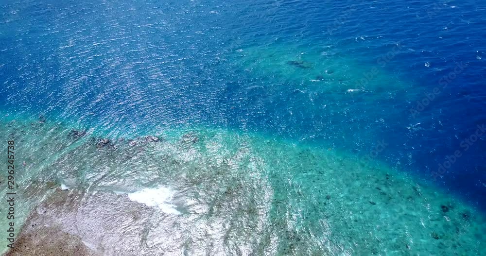 Tilt down aerial shot from white sandy beach to sea. Maldives. Tilt down aerial shot from white sandy beach to sea. Maldives.