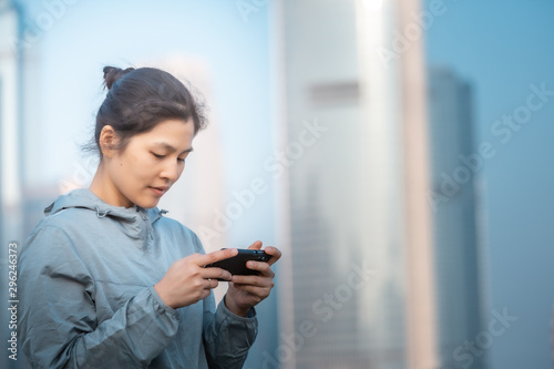 Woman playing mobile game outdoor