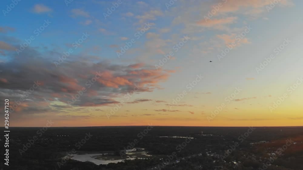 Against beautiful airplane landing flying overhead at dusk sunset Against beautiful airplane landing flying overhead at dusk sunset