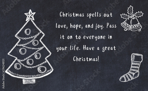 Photo Drawing of christmas tree and handwritten greetings on black chalkboard