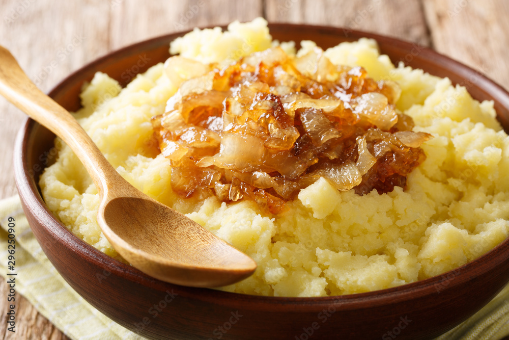 Simple food mashed potatoes with caramelized onions close-up on a plate. horizontal Simple food mashed potatoes with caramelized onions close-up on a plate. horizontal