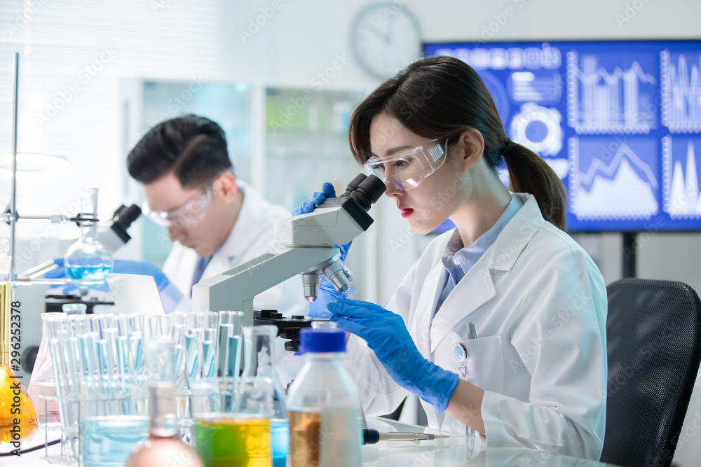 Asian scientist use microscope Asian scientist use microscope