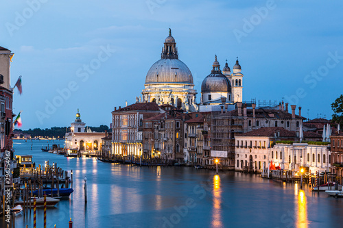 Long exposure of the Grand Canalat twilight with the Santa Maria della Salute cathedral in Venice in Italy