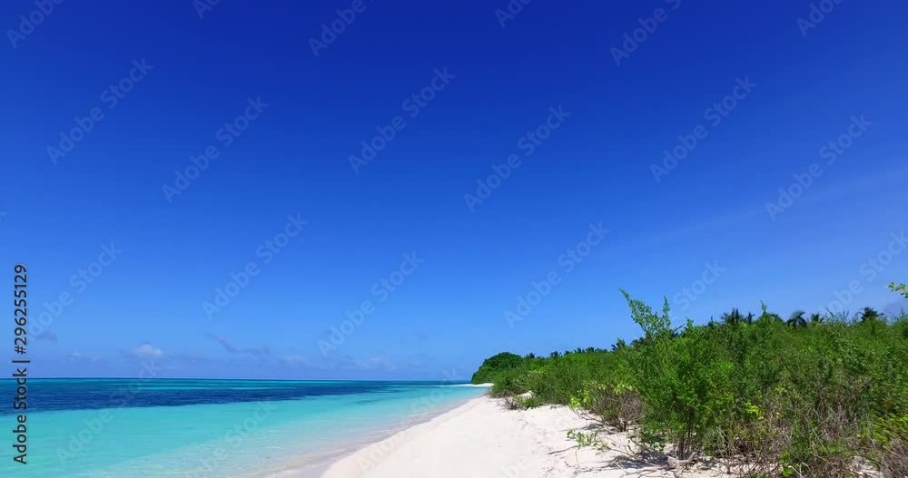 static shot of tropical island turquoise waves splashing on white sand beach, background shot with copy space static shot of tropical island turquoise waves splashing on white sand beach, background shot with copy space