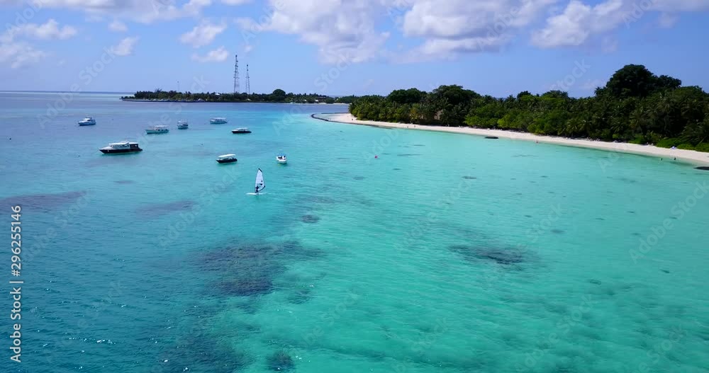 windsurfer surfing between the boats in the beautiful Caribbean atoll, Water sport on tropical islands windsurfer surfing between the boats in the beautiful Caribbean atoll, Water sport on tropical islands
