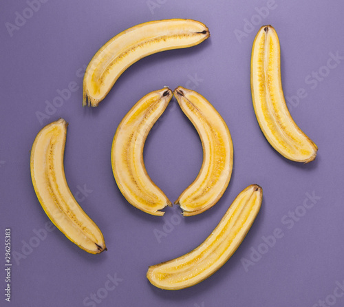 Banana halves on a purple background.