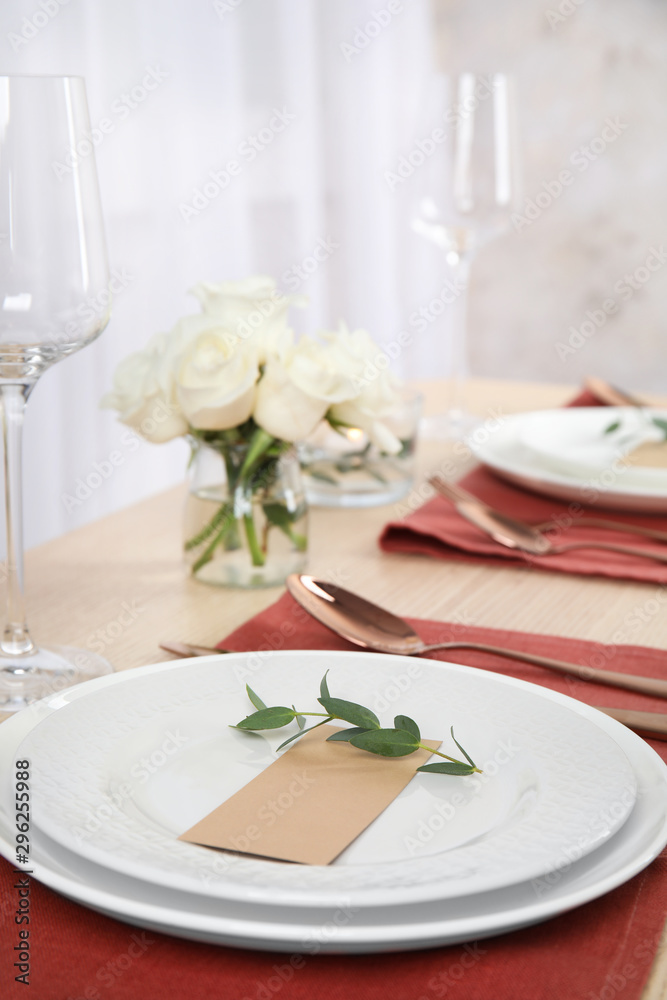 Elegant festive table setting with blank card in restaurant Elegant festive table setting with blank card in restaurant