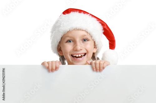 Happy child in Santa hat peeping out of blank banner on white background. Christmas celebration