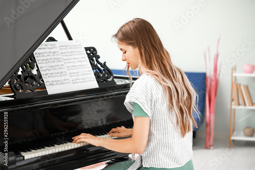 Young woman playing grand p...