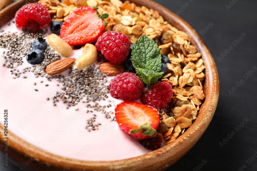 Fototapeta premium Tasty homemade granola with yogurt on dark grey table, closeup. Healthy breakfast