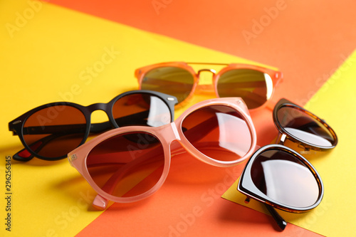 Stylish sunglasses on color background. Summer time