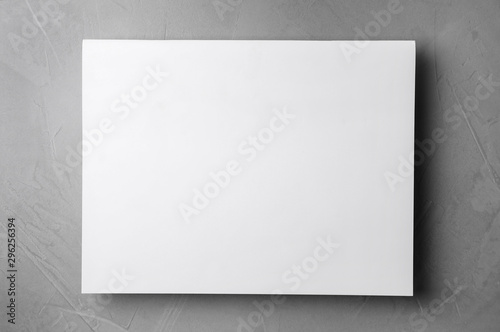 Blank paper sheets on light grey stone background, top view. Mock up for design