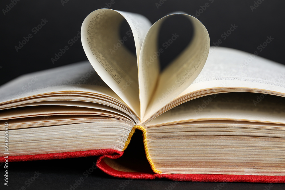 Closeup view of open book on black background Closeup view of open book on black background