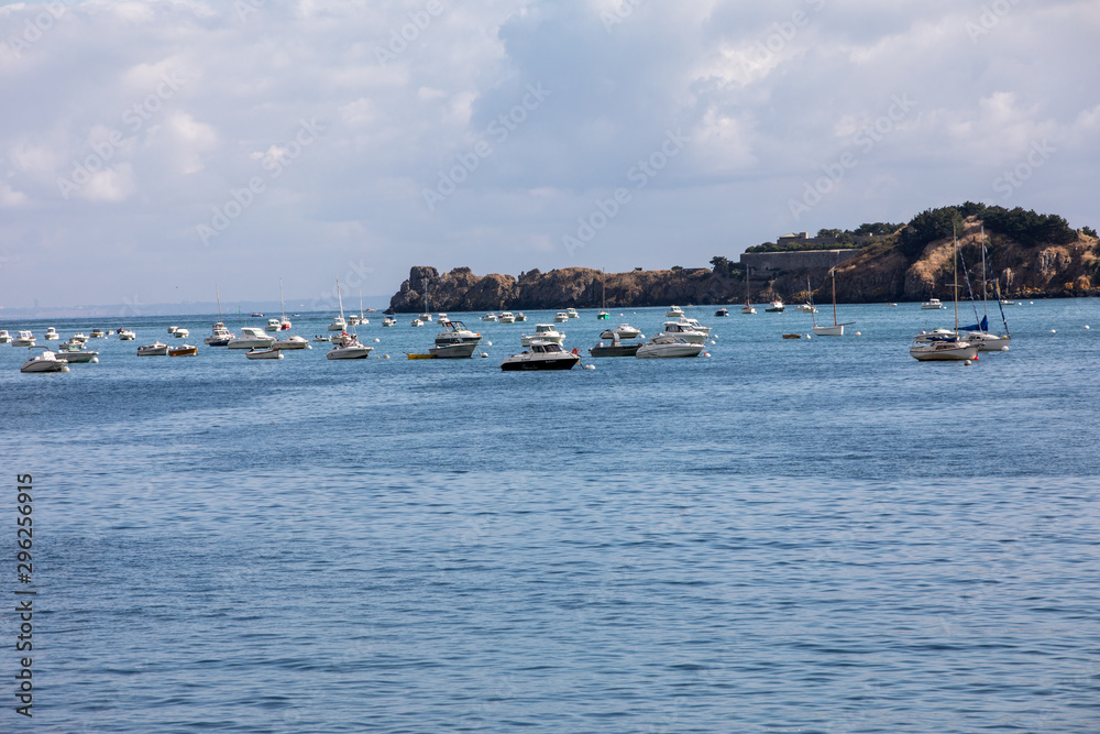  Fishing boats and yachts moored in the bay at high tide in Cancale, famous oysters production town. Brittany, France,