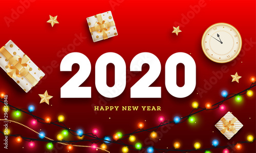 Top view of clock with gift boxes and colorful lighting garland decorated on red background for 2020 Happy New Year celebration.