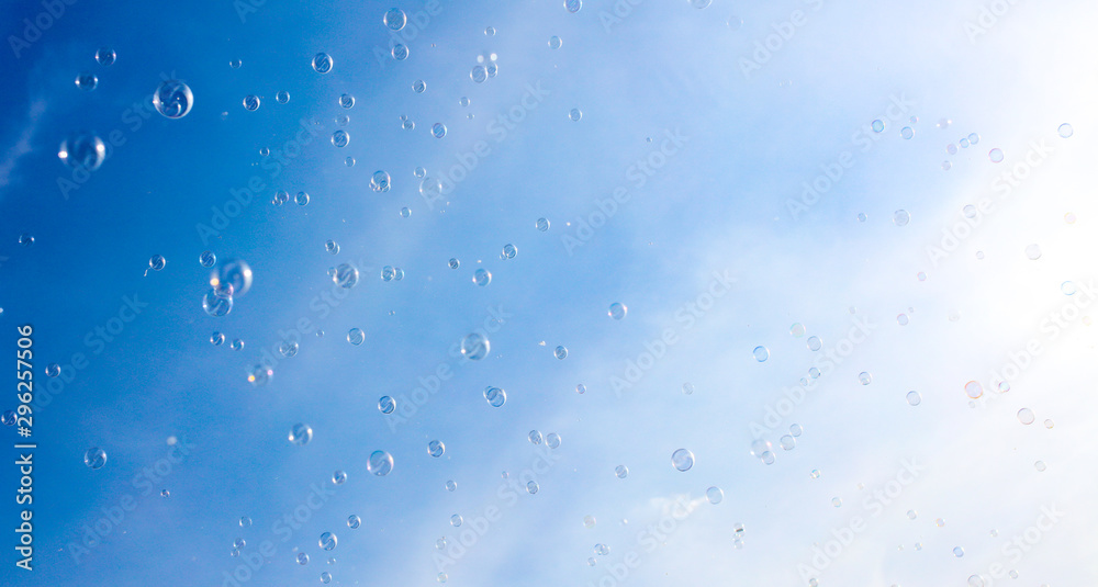 Soap bubbles fly in the blue sky