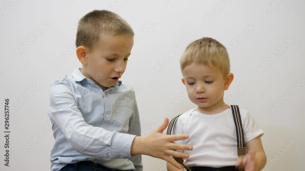 Elegant brothers give five, toddler and big brother deal, conceptual Elegant brothers give five, toddler and big brother deal, conceptual