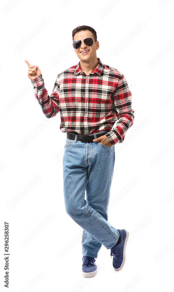 Portrait of handsome young man pointing at something on white background Portrait of handsome young man pointing at something on white background