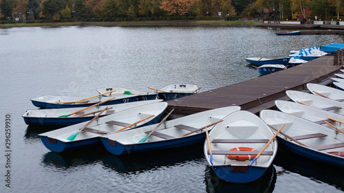 Empty boats on the pier on the lake in the city Park