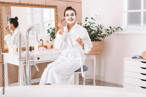 Beautiful young woman apply...
