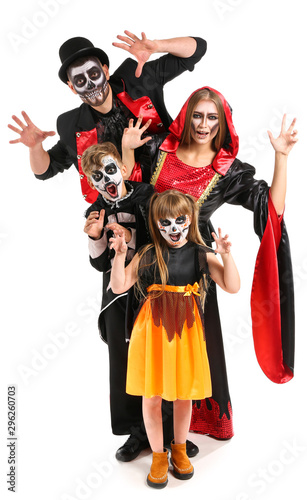 Family in Halloween costumes on white background