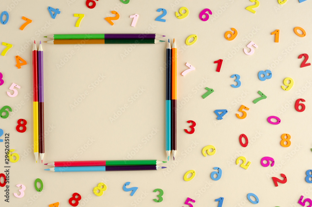 Colored wooden numbers composition on beige background. Colored wooden numbers composition on beige background.