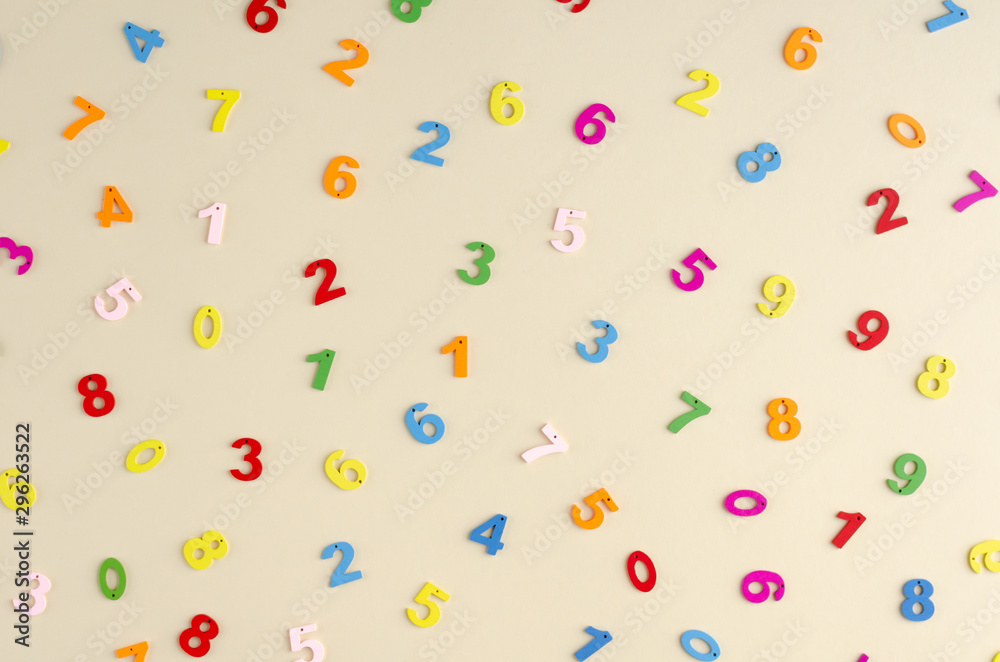 Colored wooden numbers composition on beige background. Colored wooden numbers composition on beige background.