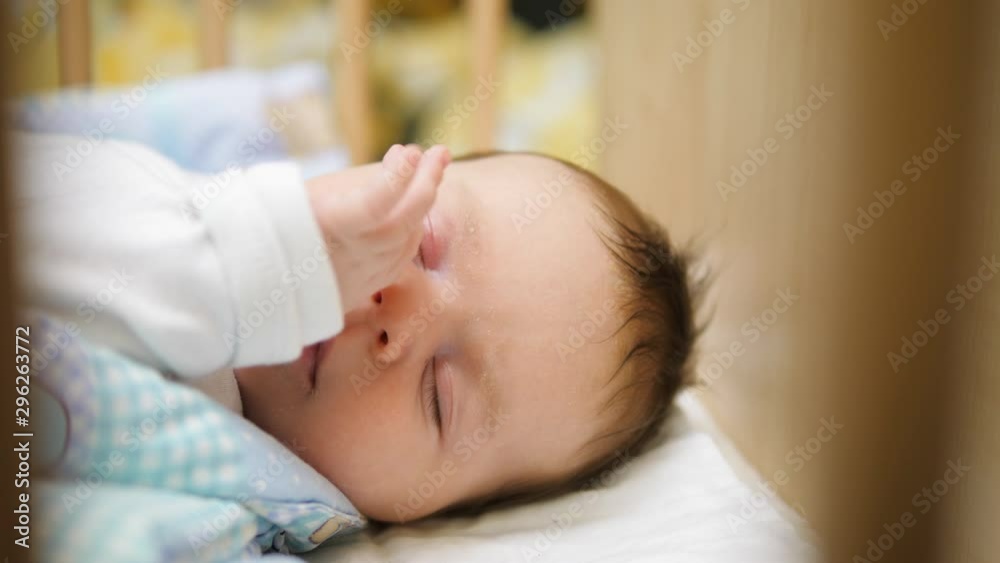 Peaceful newborn baby sleeping in wooden bed Peaceful newborn baby sleeping in wooden bed