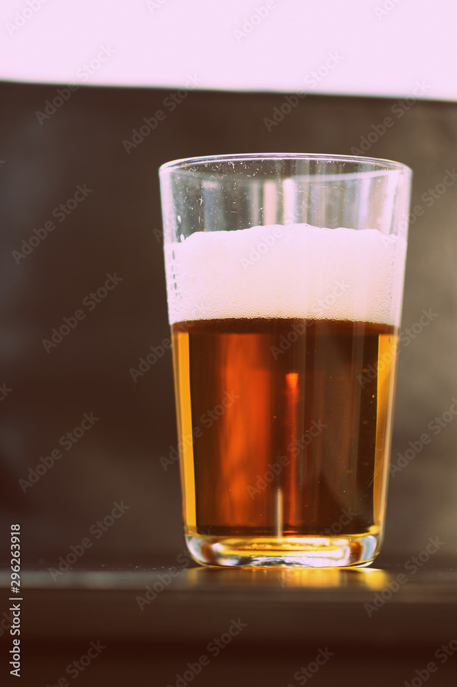 Glass with a light beer closeup in retro style