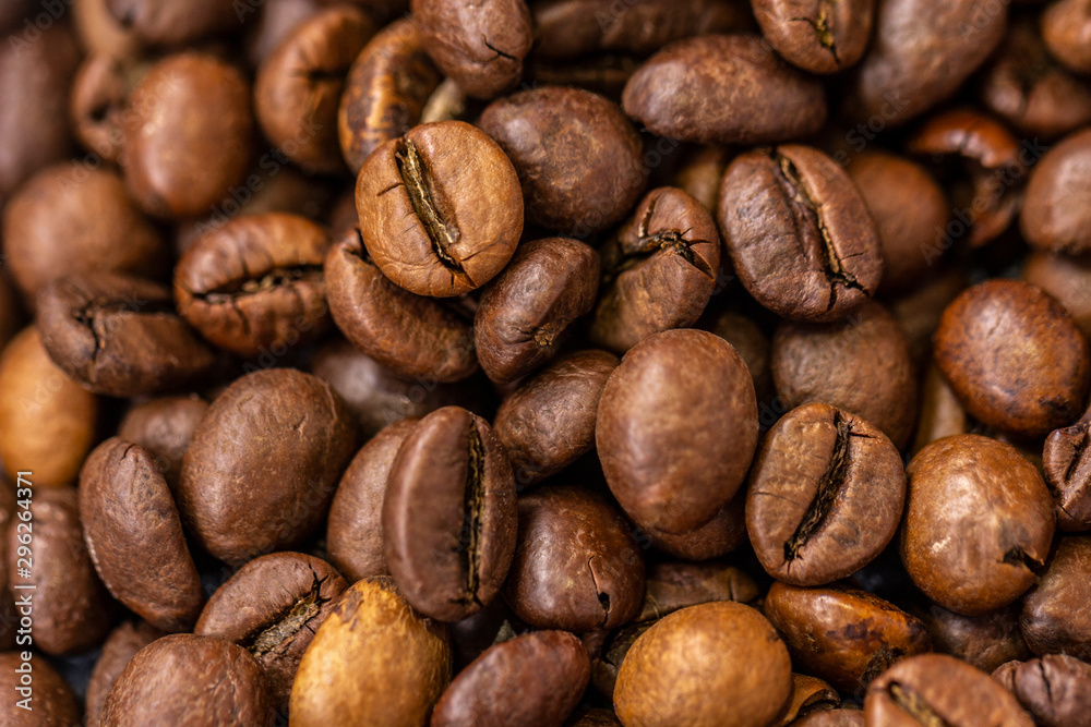 Close-up of coffee beans on wooden background Close-up of coffee beans on wooden background