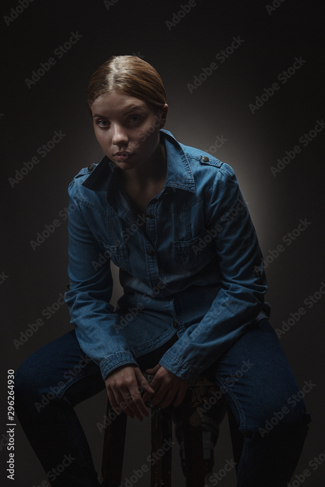 Blonde woman in white t-shirt with dramatic light. Blonde woman in white t-shirt with dramatic light.