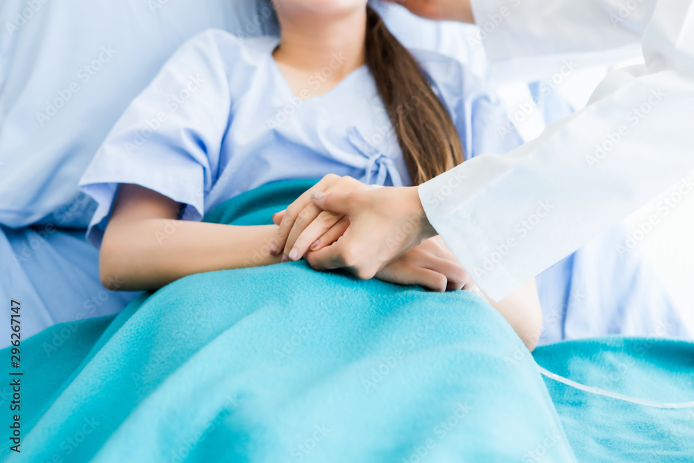 Doctor discussing take care with positive emotions to asian young female patient on bed in hospital background. Doctor discussing take care with positive emotions to asian young female patient on bed in hospital background.