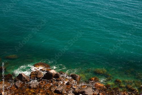 Emerald water and rocky shores of the Black Sea. Rocky shores washed by the turquoise sea.