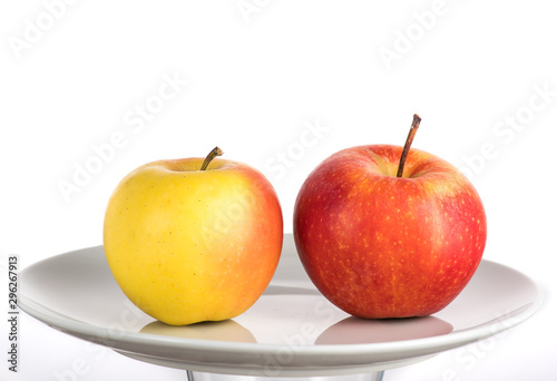 red and yellow apple on a white plate on a white background