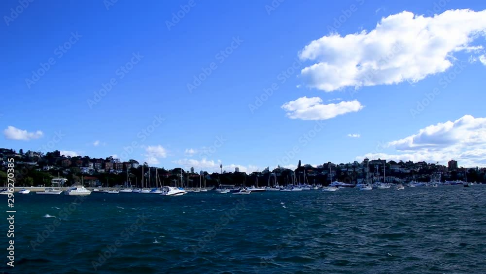 Waves gently moving boats in harbour on a cloudy day Waves gently moving boats in harbour on a cloudy day
