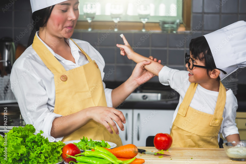 Asian woman young mother with son boy cooking salad mom sliced vegetables food son tasting salad dressing vegetable carrots and tomatoes bell peppers happy family cook food enjoyment lifestyle kitchen Asian woman young mother with son boy cooking salad mom sliced vegetables food son tasting salad dressing vegetable carrots and tomatoes bell peppers happy family cook food enjoyment lifestyle kitchen
