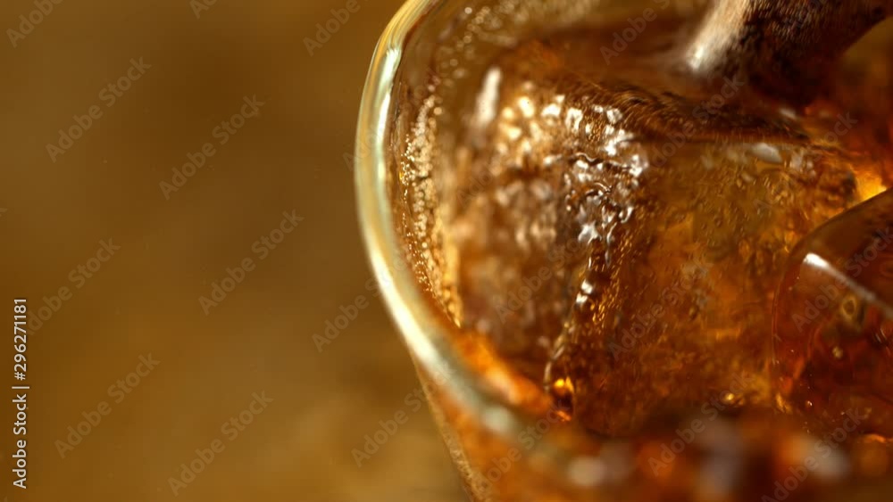 Super Slow Motion Macro Shot of Pouring Fresh Cola into Glass with Ice Cubes at 1000fps. Super Slow Motion Macro Shot of Pouring Fresh Cola into Glass with Ice Cubes at 1000fps.