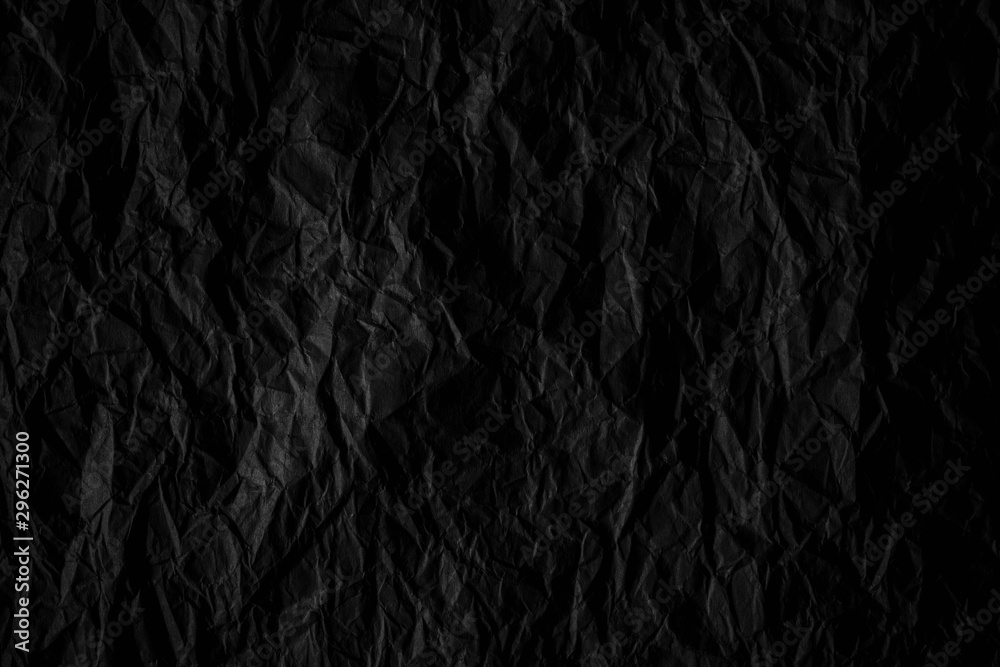 Dark black crumpled paper close up texture background Dark black crumpled paper close up texture background