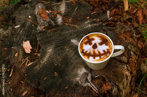 Coffee cup as jack o lantern pumpkin