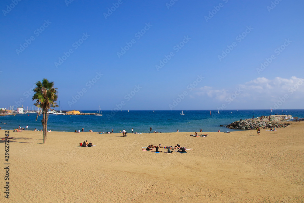 The beach of Barcelona with sailboats and people, Catalonia - Spain